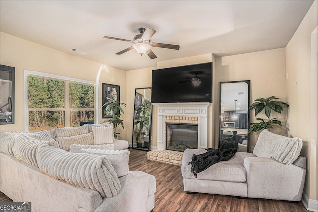 living room featuring a fireplace, dark hardwood / wood-style flooring, and ceiling fan