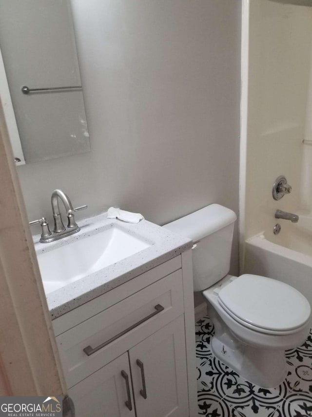 full bathroom with shower / tub combination, tile patterned floors, vanity, and toilet