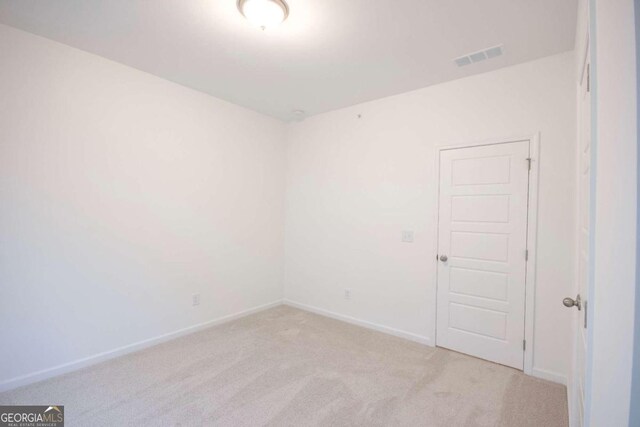 empty room featuring light colored carpet