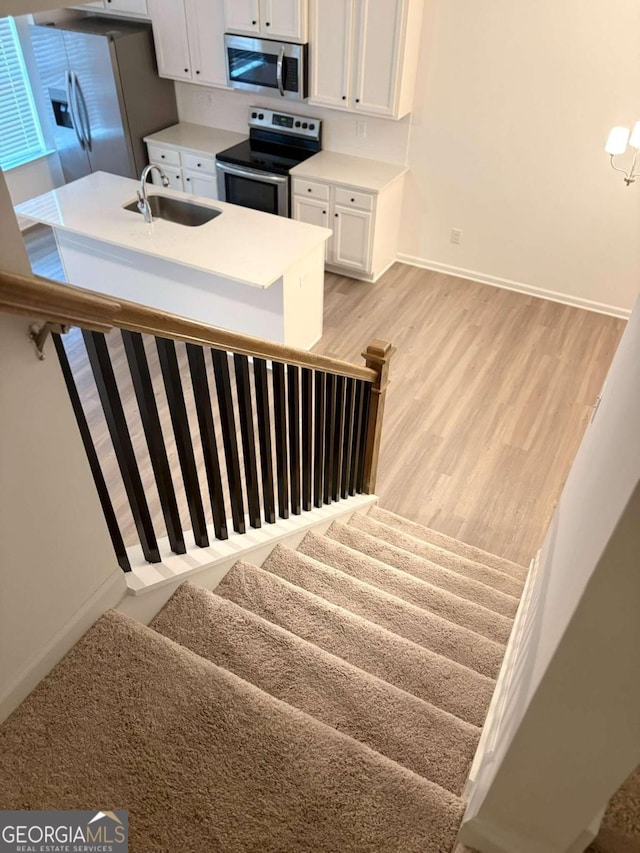 stairway featuring carpet