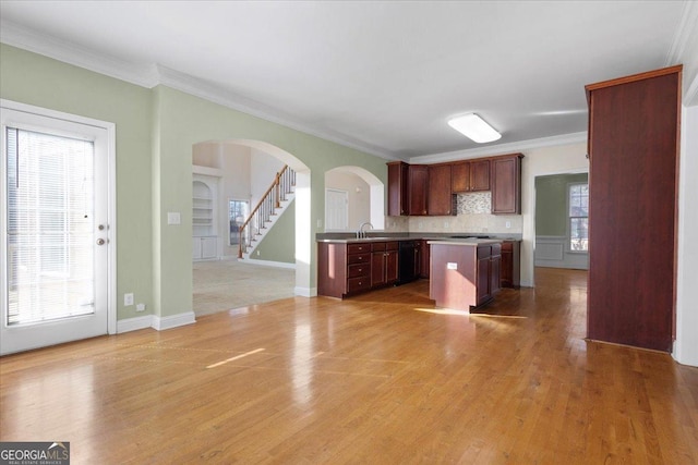 kitchen with tasteful backsplash, black appliances, ornamental molding, and light hardwood / wood-style floors