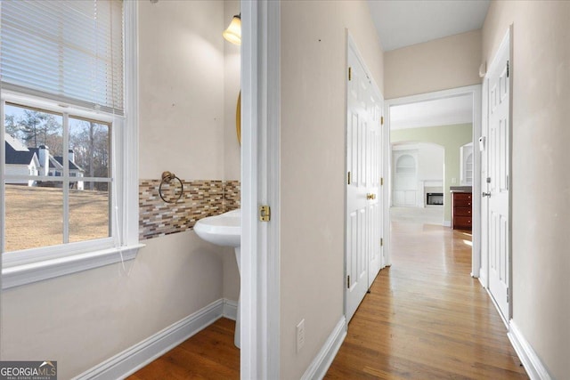 hallway with hardwood / wood-style flooring