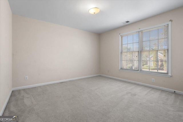 empty room with light colored carpet