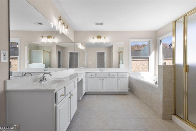 bathroom with tile patterned flooring, vanity, and shower with separate bathtub