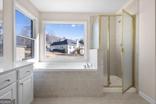 bathroom with a healthy amount of sunlight and separate shower and tub