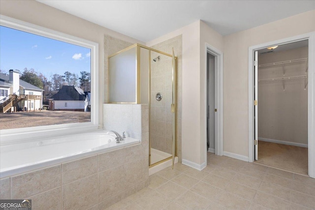 bathroom featuring tile patterned floors and separate shower and tub