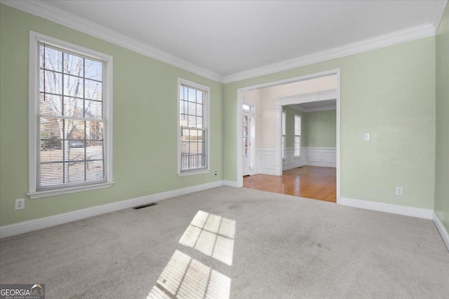 carpeted spare room with ornamental molding