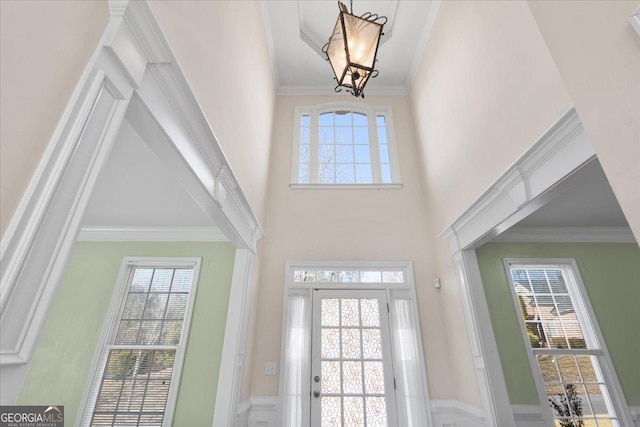 doorway to outside with ornamental molding