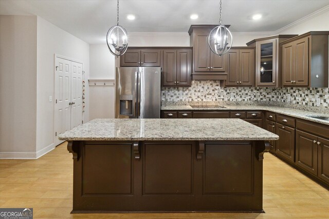 kitchen featuring stainless steel fridge with ice dispenser, dark brown cabinetry, and a chandelier