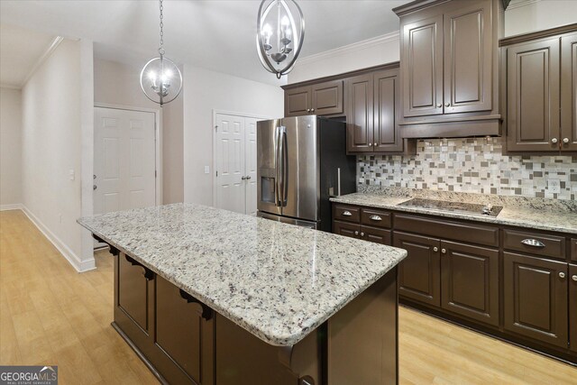 kitchen featuring a center island, stainless steel fridge with ice dispenser, black electric cooktop, decorative backsplash, and dark brown cabinets