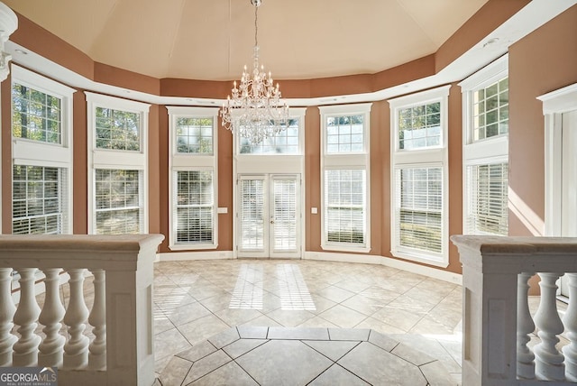 unfurnished sunroom featuring plenty of natural light and a chandelier