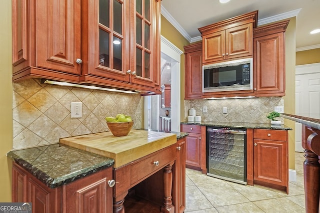 kitchen with light tile patterned floors, built in microwave, beverage cooler, and ornamental molding