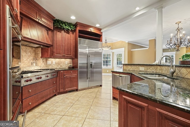 kitchen with decorative light fixtures, backsplash, stainless steel appliances, and an inviting chandelier