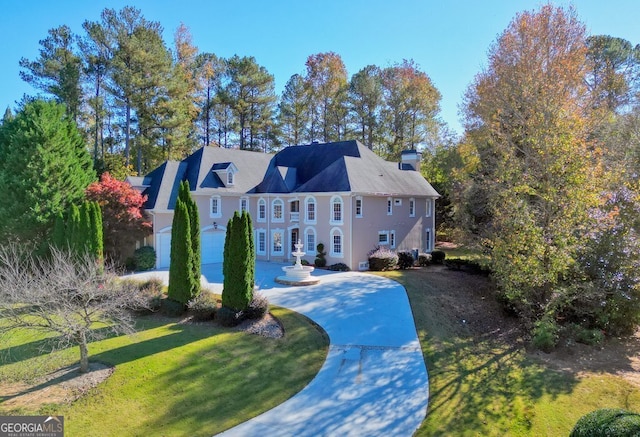 view of front of property featuring a front lawn and a garage