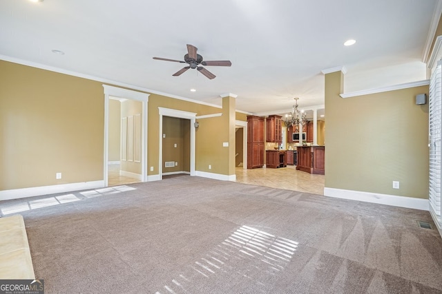 unfurnished living room with ceiling fan with notable chandelier, light colored carpet, and crown molding