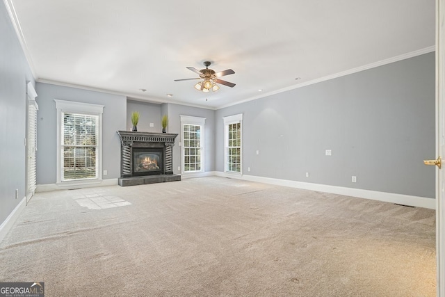 unfurnished living room featuring light colored carpet, a wealth of natural light, ornamental molding, and ceiling fan