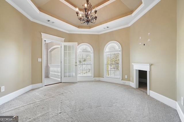 interior space featuring a chandelier, crown molding, light carpet, and a tray ceiling