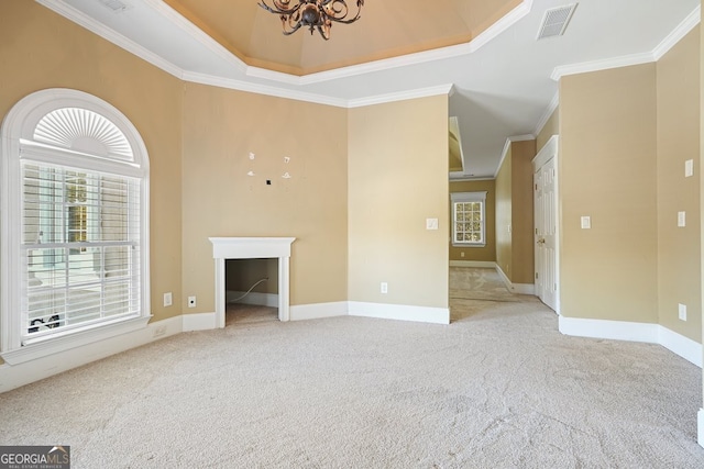 unfurnished living room with a raised ceiling, light carpet, a notable chandelier, and ornamental molding