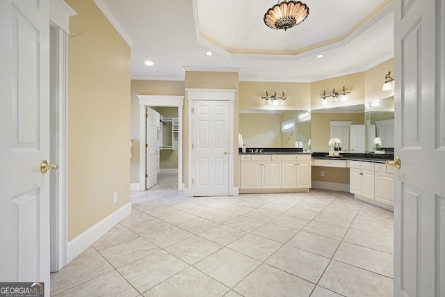 bathroom with crown molding, tile patterned flooring, and vanity