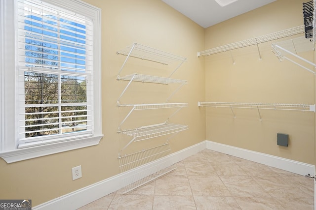 spacious closet featuring tile patterned flooring