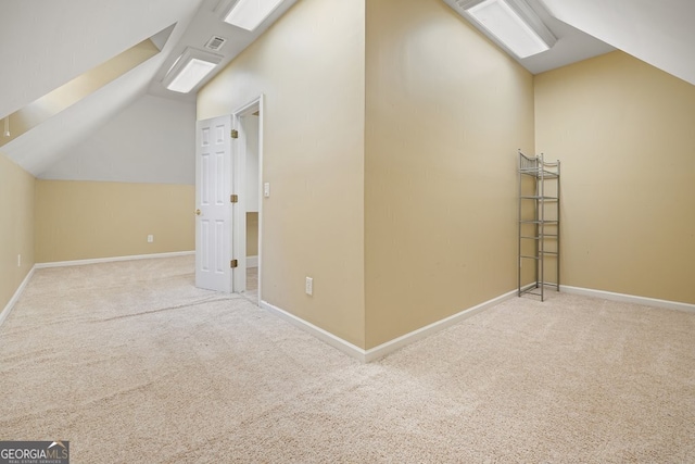 bonus room with light colored carpet and vaulted ceiling