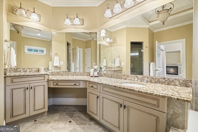 bathroom featuring tile patterned flooring, vanity, a shower with door, and ornamental molding