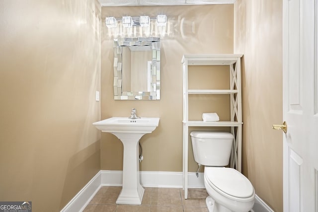 bathroom with toilet and tile patterned floors