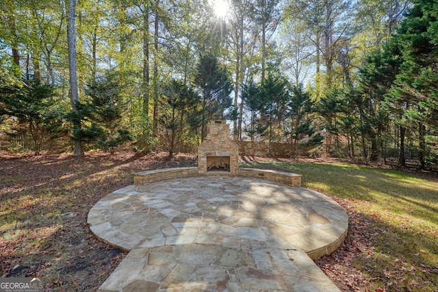 view of patio featuring an outdoor stone fireplace