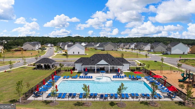 view of pool featuring a playground and a patio