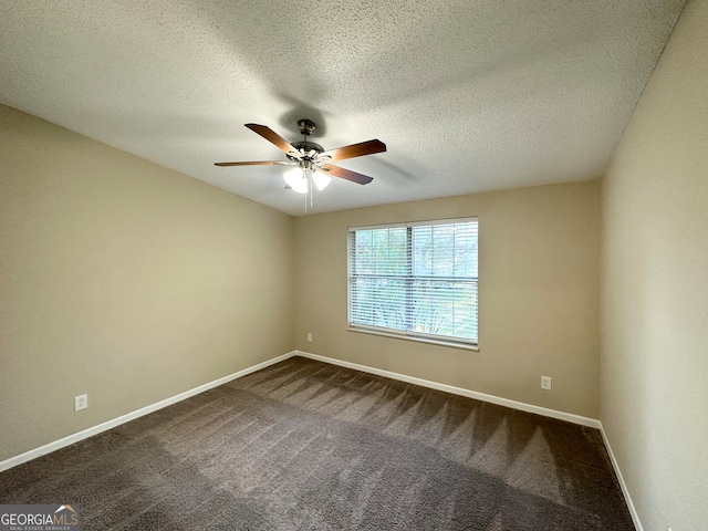 spare room featuring carpet flooring, ceiling fan, and a textured ceiling