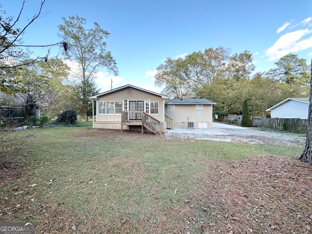 rear view of house with a lawn