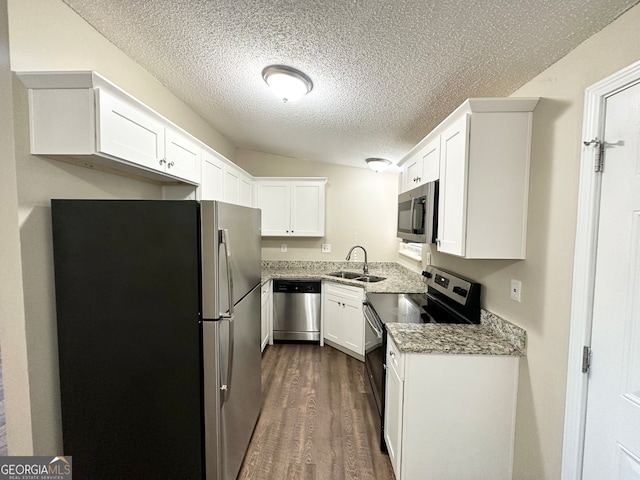 kitchen with dark hardwood / wood-style floors, white cabinetry, sink, and appliances with stainless steel finishes