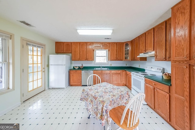 kitchen featuring white appliances and sink