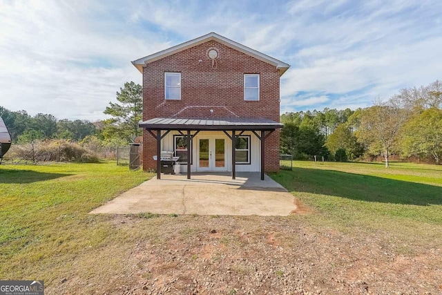 back of property with french doors, a yard, and a patio