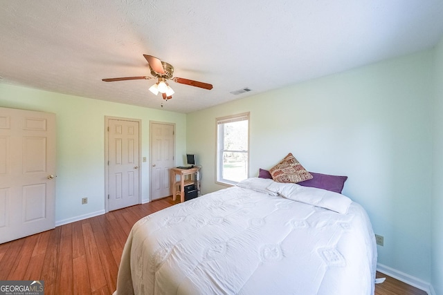 bedroom featuring hardwood / wood-style flooring and ceiling fan