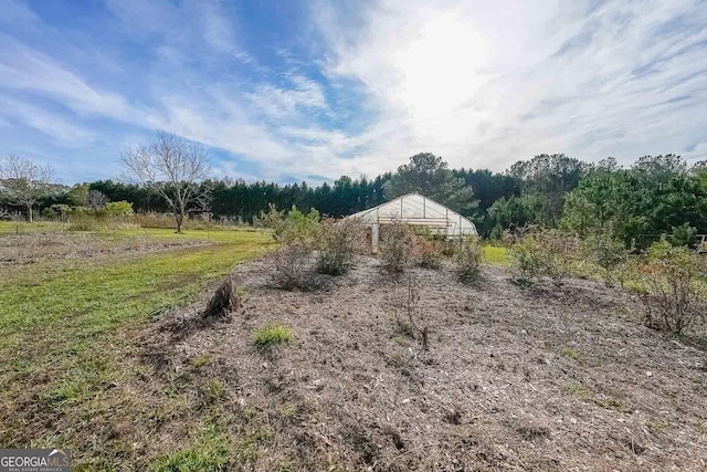 view of yard with an outbuilding and a rural view