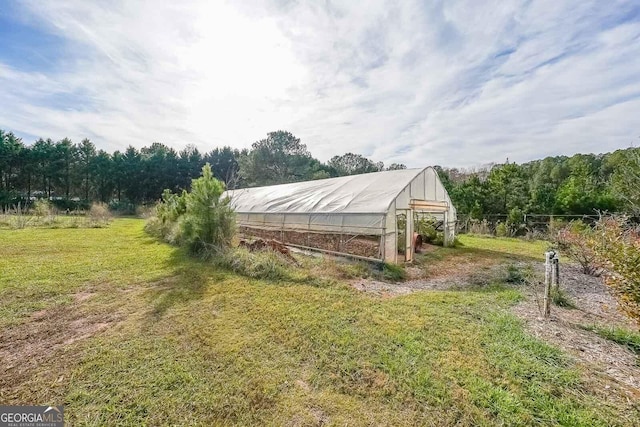 view of outbuilding featuring a lawn