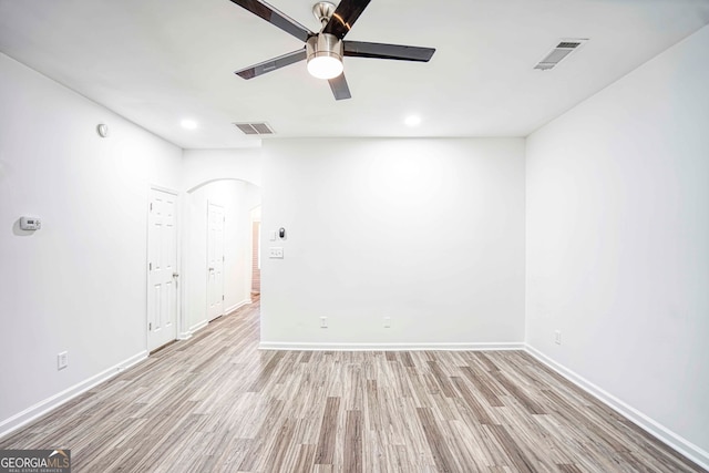 spare room with ceiling fan and light wood-type flooring