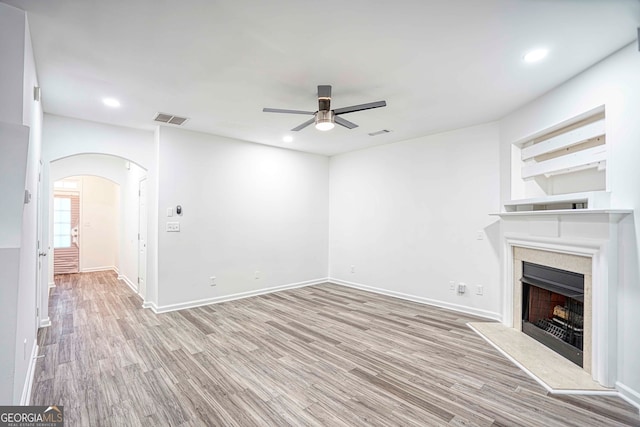 unfurnished living room with light hardwood / wood-style flooring and ceiling fan