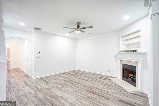 unfurnished living room featuring light hardwood / wood-style floors and ceiling fan