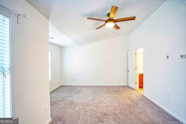 empty room with light carpet, vaulted ceiling, and ceiling fan