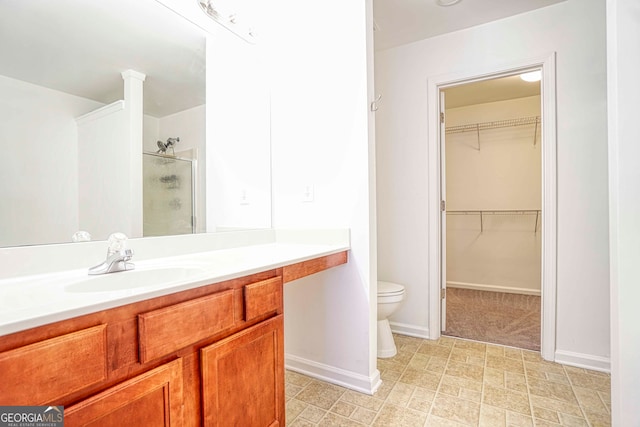 bathroom featuring vanity, toilet, and walk in shower