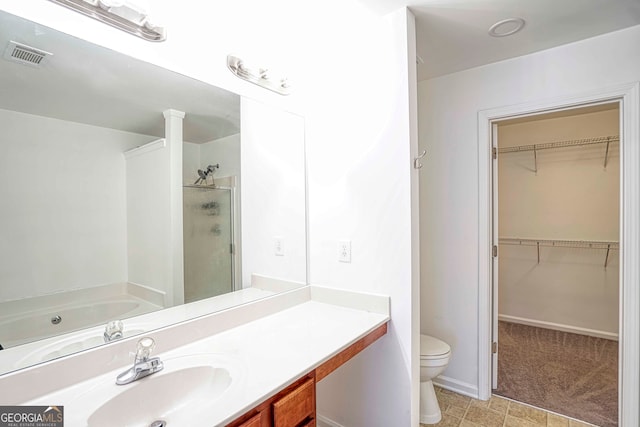 full bathroom featuring shower with separate bathtub, vanity, and toilet