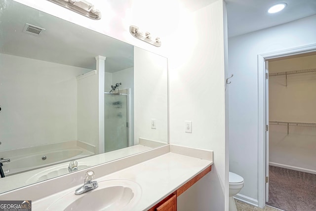 full bathroom featuring separate shower and tub, vanity, and toilet