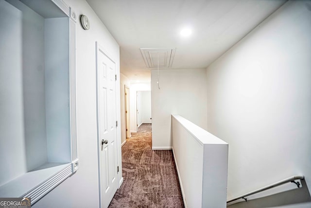 hallway featuring dark colored carpet