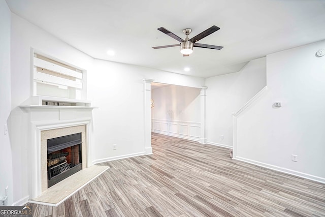 unfurnished living room featuring ceiling fan and light hardwood / wood-style flooring