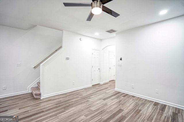 spare room with ceiling fan and wood-type flooring