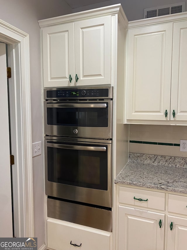 kitchen featuring white cabinets