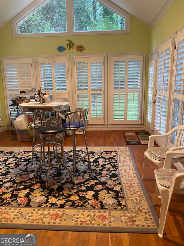 sunroom featuring vaulted ceiling