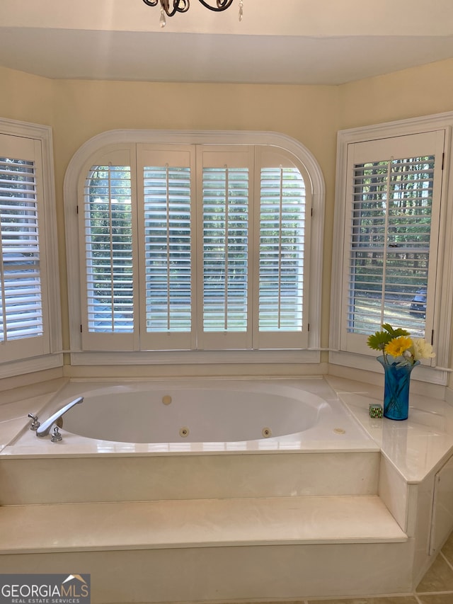 bathroom with tile patterned floors and a bathtub